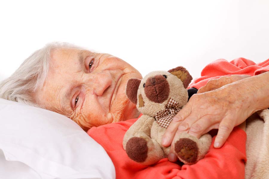 elderly patient cuddling teddy bear