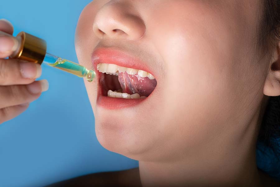 woman using a dropper for oral liquid medicine